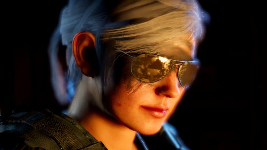 The Division 2 - a silver-haired lady wearing damaged sunglasses and body armour