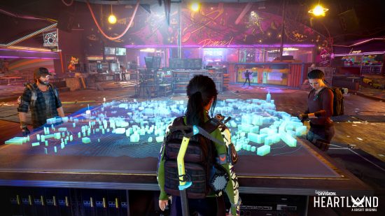 The Division Heartland - three people stand around a large war table with a 3D digital projection showing the map of Silver Creek on it
