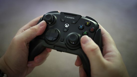 The Moga XP Ultra PC controller being held in the hand