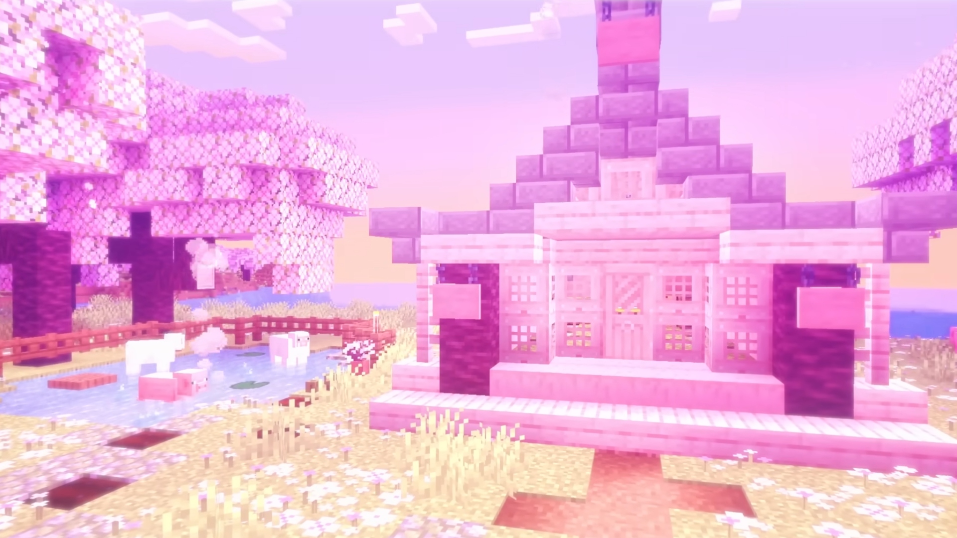 Best cross-platform games: Minecraft. Image shows a house created in the game, surrounded by sheep and cherry blossoms.