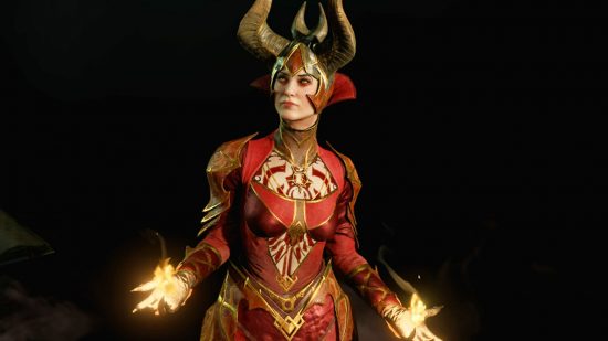 Diablo 4 Ashava is difficult, but your teammates aren't the problem: A woman in red and gold armour with a pointed golden helmet stands conjoring flames on a black background