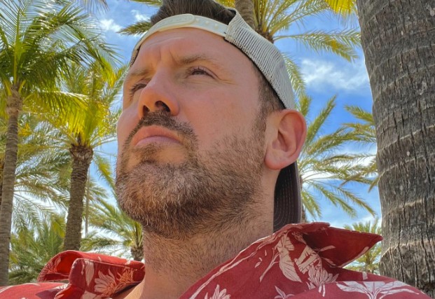 GTA 6 news could be soon, as Jason actor shares Vice City-style tease: A man in a backwards cap and an Hawaiian shirt sitting in front of some palm trees