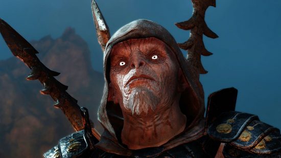Get the best Lord of the Rings games for 90% off: a pale orc with a hood looks off screen, with bright eyes and a hood, with weapons on their back