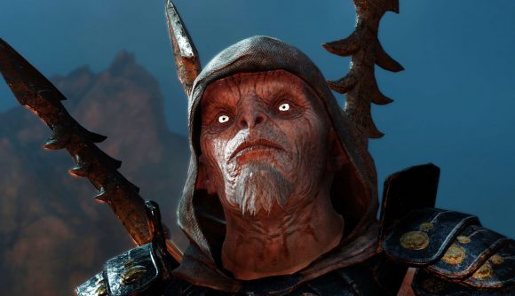 Get the best Lord of the Rings games for 90% off: a pale orc with a hood looks off screen, with bright eyes and a hood, with weapons on their back
