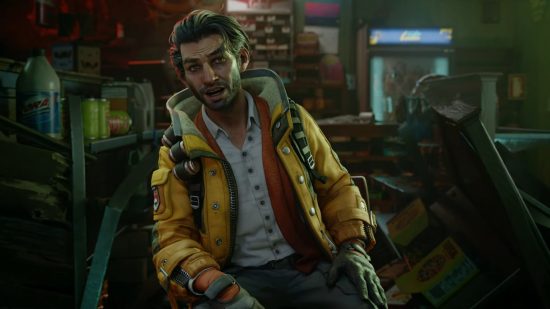 Redfall Devinder build: a medium shot of Devinder, a man in a yellow jacket, sitting down.