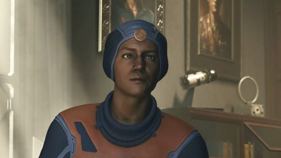 Starfield slip up suggests a softer edge than Fallout: someone in a blue shower cap looking headgear looks just off camera, in orange and blue clothes