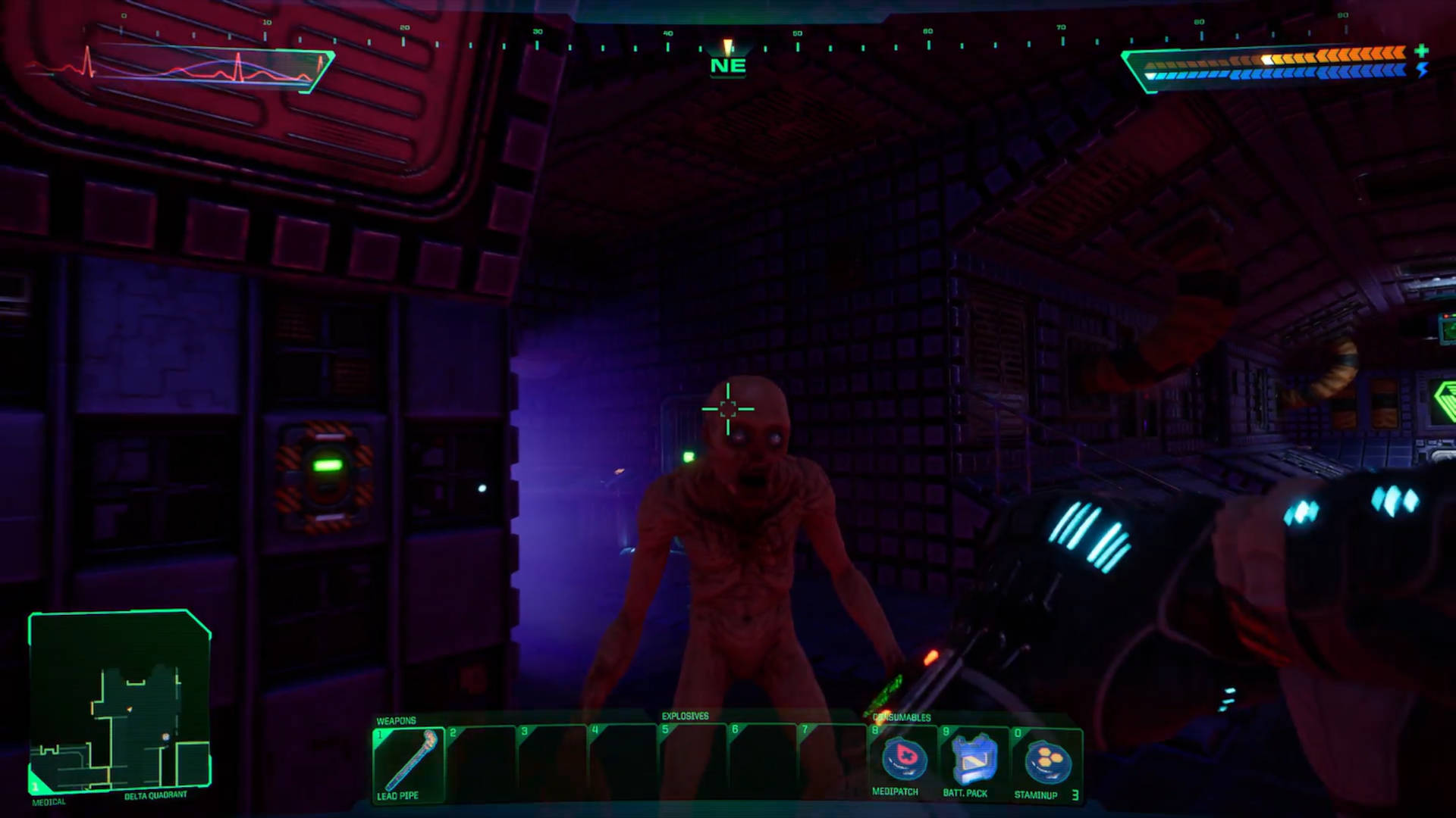 System Shock review - a very dark room where the Hacker is about to shoot a zombie mutant. This image is intentionally left dark.