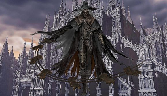 Bloodborne character standing before fan's recreation of the game in Minecraft