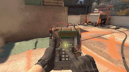 Counter-Strike 2 patch notes - first-person view of someone using a keypad to arm a device.