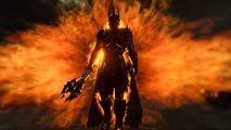 Sauron from The Lord of the Rings standing with a staff in hand amid fiery flames