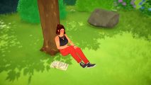 A female character from Paralives sitting on the grass with her back against a tree and an open book to her right