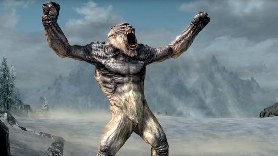 An enraged frost troll from The Elder Scrolls Skryim standing atop a mountain's edge with his arms extended