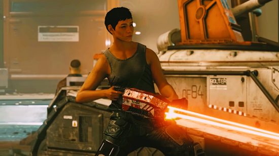 A short-haired woman in a gray tank top shoots a red laser
