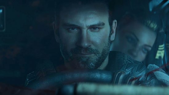 A white male character sits behind the wheel of a car looking directly forward and smirking