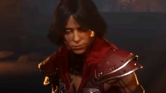A female Diablo 4 rogue wearing red smiles as she looks straight forward