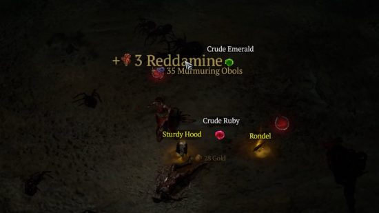 Reddamine, one of the many Diablo 4 resources, and other valuable items, lay on the floor having burst from a chest.