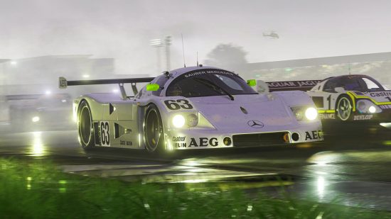 A white racing car takes center frame with grass in the foreground and bright headlights.