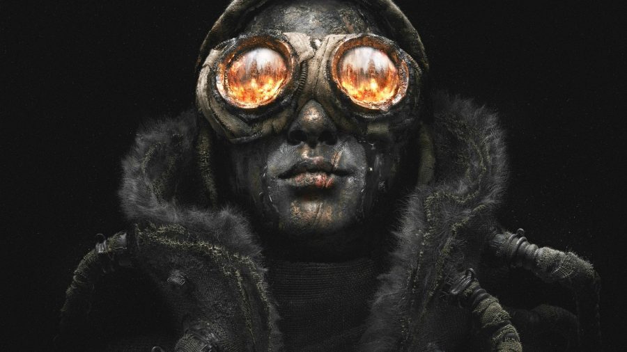 Frostpunk 2: A man with oil on his face and circular goggles stands looking up as fire reflects in the glass