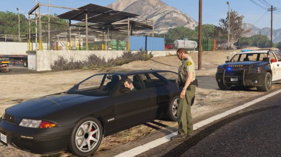 Best GTA 5 mods: a cop has pulled over Michael, who was driving a black car presumably because of his speed.