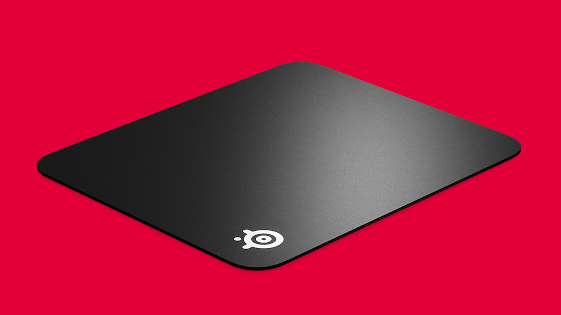 Hard vs soft mouse mat gaming: A hard Steelseries mouse mat on a red background