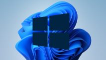 Microsoft Windows 10 logo stands in front of the Windows 11 bloom logo.