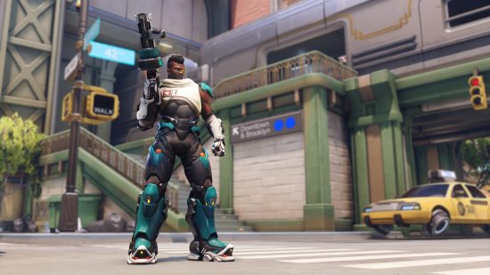 Overwatch 2 characters: a man wearing a tactical military style suit holds a large autmatic weapon.
