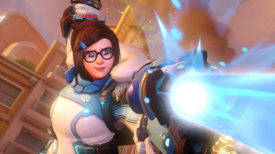 Overwatch 2 characters: a woman with brown hair and glasses holds a gun that fires ice rays.