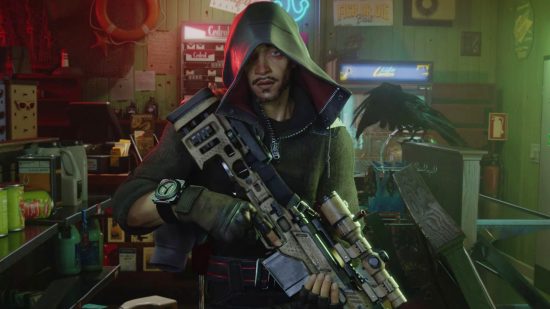 A tanned, hooded man with a goatee standing holding a sniper rifle in a basement location