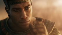 Ramesses is one of the eight Total War Pharaoh leaders available at launch. He is looking at a dung beetle on his finger.