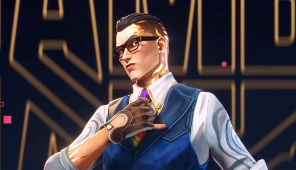 Valorant patch notes - update 6 11 brings in some big Chamber buffs: Valorant agent Chamber, with a shirt and vest and slicked back brown hair, stands adjusting his tie