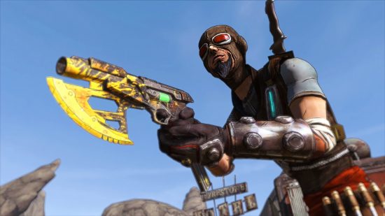A man wearing a face mask and holding a yellow weapon stands smiling
