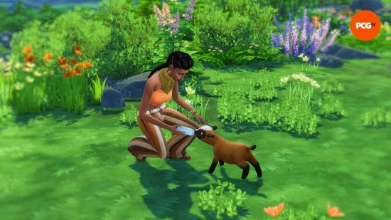 A female Sim wearing an orange crop top bottle feeds a mini goat in a grassy field with flowers