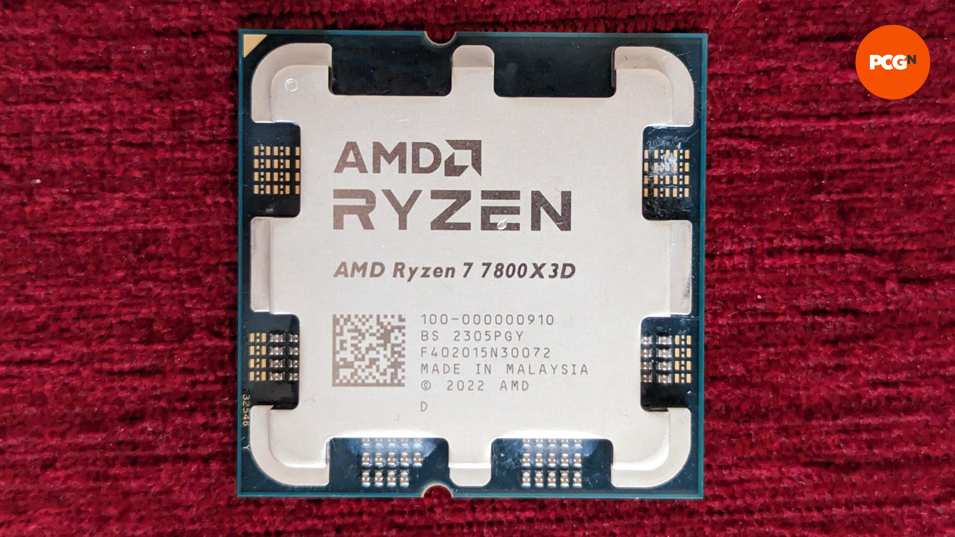 AMD Ryzen 7 7800X3D review: CPU rests on a red surface