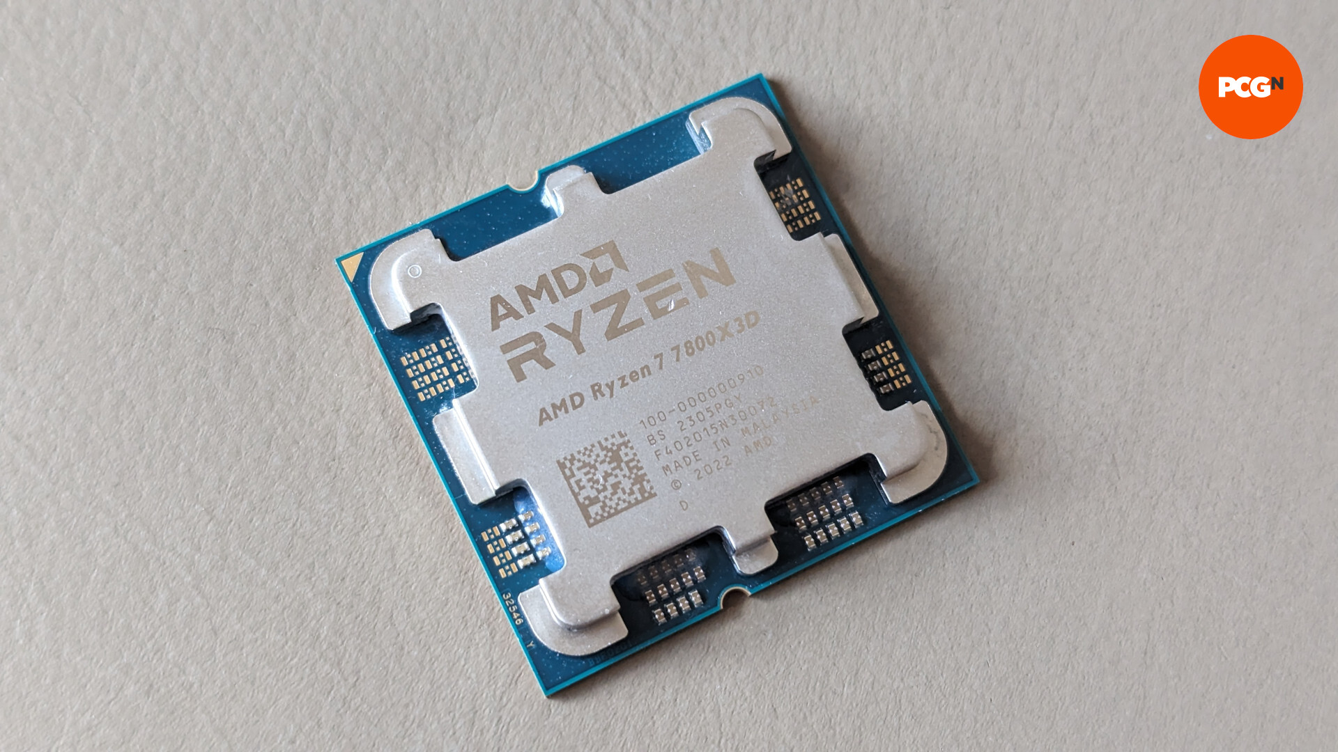 AMD Ryzen 7 7800X3D review: The CPU rests against a cream background