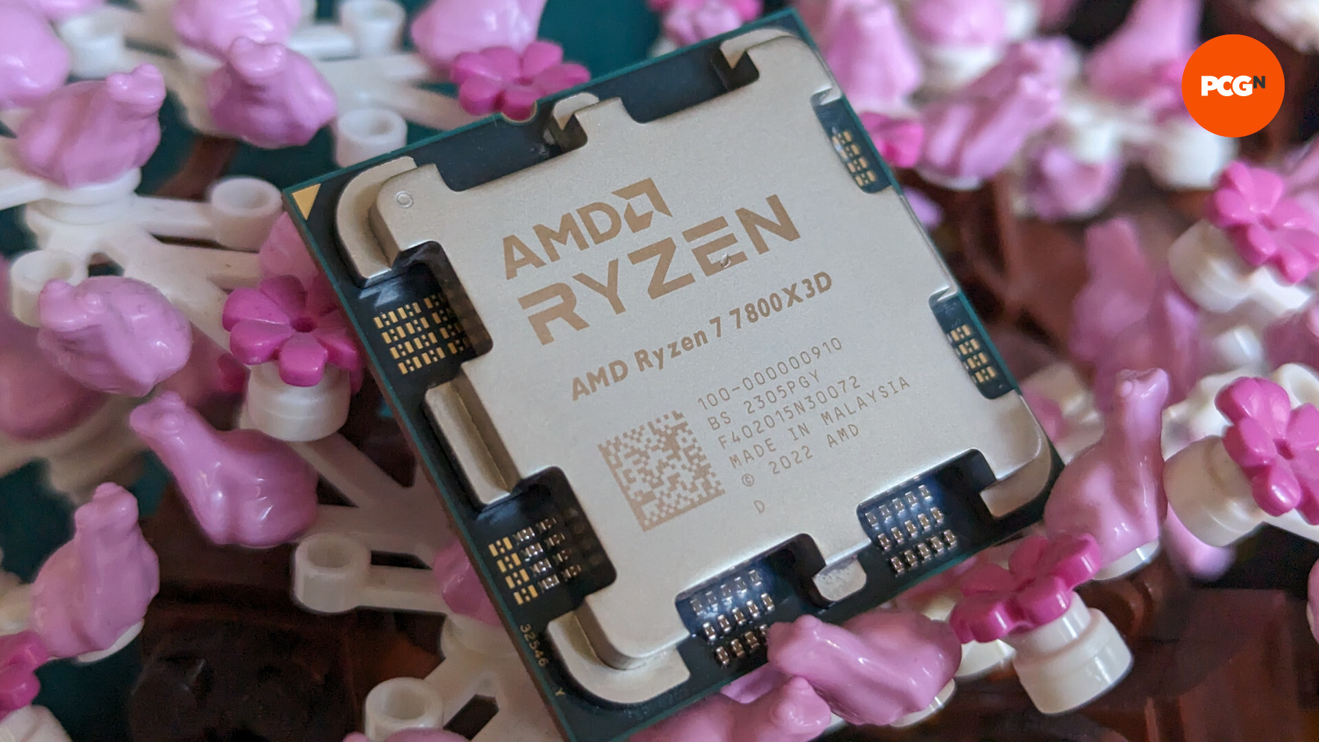 AMD Ryzen 7 7800X3D review: CPU rests against a background of pink and white Lego