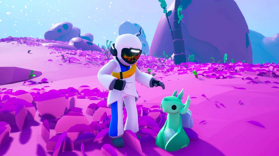 Astroneer - an astronaut on a purple planet reaches out to pet a small, jade green alien creature.