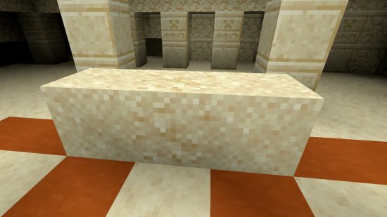 A block of Minecraft suspicious sand with a block of normal sand on either side, showing the difference in appearance between the blocks, and the slightly darker pixels in the suspicious sand.