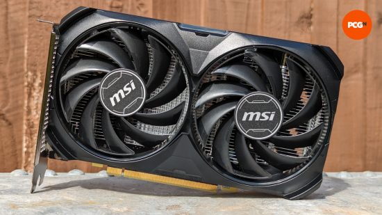 Nvidia GeForce RTX 4060 review: An MSI model of the GPU against a wood backdrop, sat on a metal surface