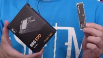 A close up of a knock-off Samsung SSD, with a YouTuber holding the box in one hand and the actual SSD in the other.