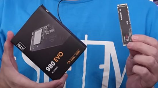 A close up of a knock-off Samsung SSD, with a YouTuber holding the box in one hand and the actual SSD in the other.