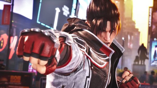 Tekken 8 tier list: Jin Kazama is wearing a white and black bomber jacket with a black hoodie and red gloves. He is standing in the middle of Times Square.