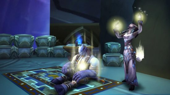 A Draenei man sitting on a carpet being healed by a chanting woman who is summoning light in her hands