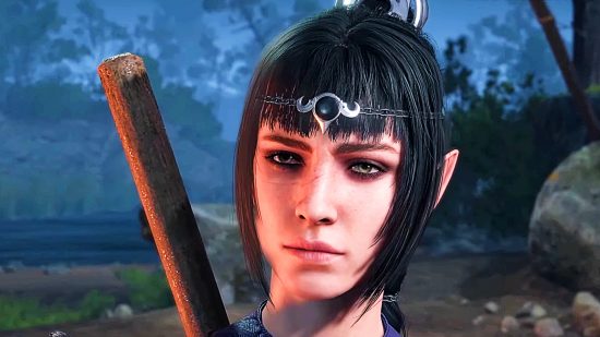 A woman with black hair topped by a circlet and bangs framing her face, stares ahead