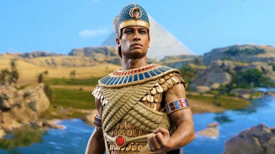 Total War Pharaoh: an Egyptian pharaoh stands before a pyramid backdrop, his fist out in front of him as he looks proud
