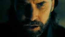 Alan Wake 2 combat - close-up on the face of the bearded author.