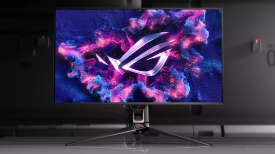 The ASUS ROG PG32CDM OLED gaming monitor sits atop a grey surface, with the company logo displaying on its screen