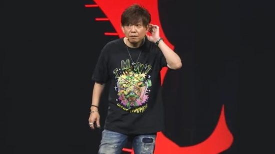 FFXIV Dawntrail release date - Final Fantasy XIV director Naoki Yoshida wearing a TMNT shirt on-stage at Fan Fest during the expansion reveal, teasing its upcoming jobs.
