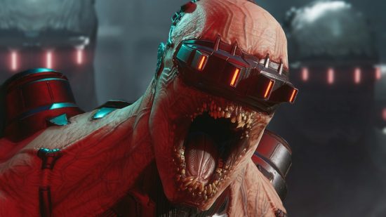 Killing Floor 3 release date: a close up of a Fleshpound baring its many rows of teeth, red lights glowing from the headset fixed over its eyes.