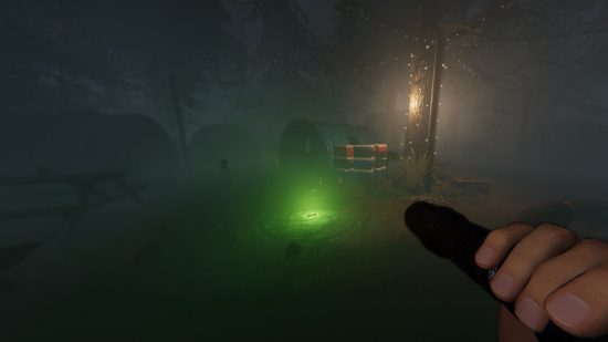 Phasmophobia Ascension update - A player holds up a torch towards a glowing green device on the ground.