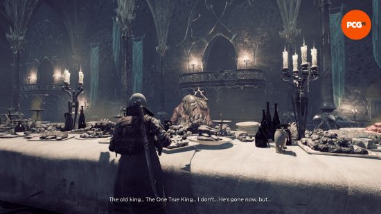 Remnant 2 patch notes August 10 2023 - A character stands in front of a table laden with questionable-looking food. A figure sits behind the table, lamenting about the One True King.